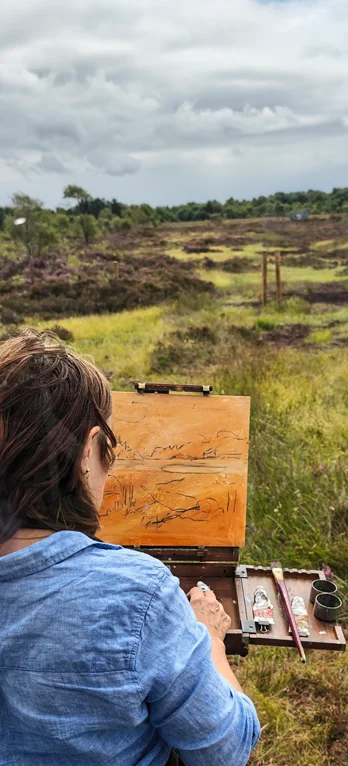 Artist painting at an easel on Cornafulla Bog
