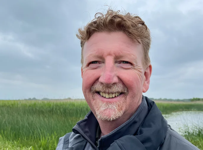 man in front of river landscape