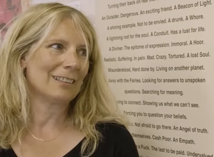 Woman in front of large text print